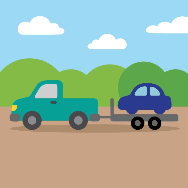 Grass green, gray, and teal car trailer behind pickup among trees, hills, or mountains with a winding path or river nearby.