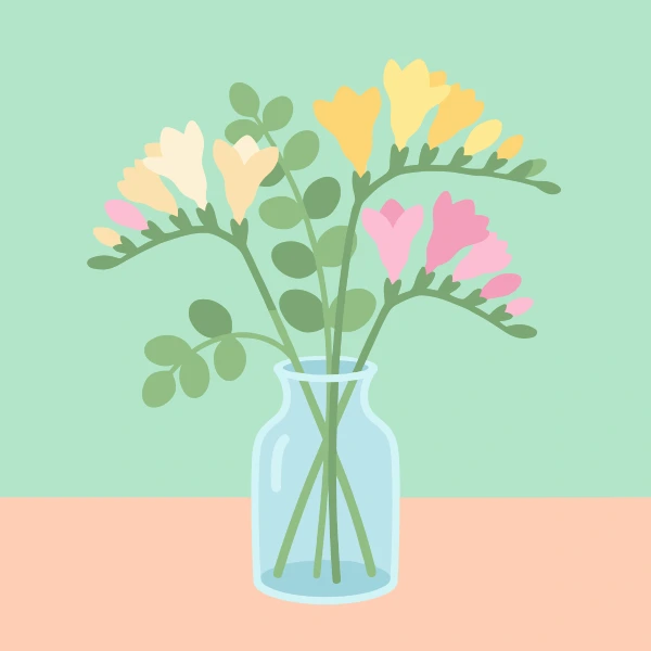 Yellow, pink, and cream freesia stems with round leaves in a clear glass jar on a peach table