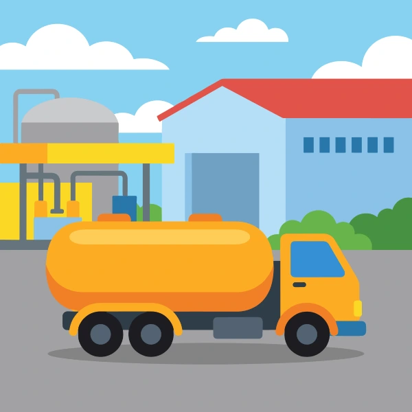 Orange fuel tanker truck with a rounded yellow tank body parked at a fuel depot with a grey storage tank, yellow canopy, and a blue warehouse building with a red roof.