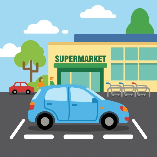 Forest green, sand beige, and grass green hatchback in front of colorful buildings, storefronts, signs, and clean pavement.