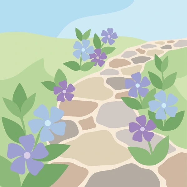 Purple and blue-violet periwinkle flowers with five petals lining both sides of a winding stone cobblestone path on a gentle green hillside