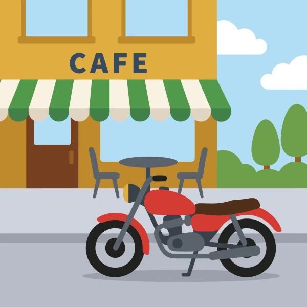 Orange, light gray, and forest green street motorcycle in front of colorful buildings, storefronts, signs, and clean pavement.